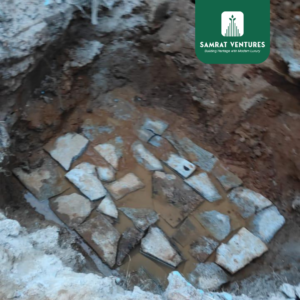 Boulders and aggregates being laid as part of the soling method to prepare the ground for the foundation at Kogilu.